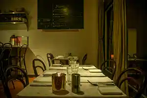 Thumbnail of Bistro Elan's interior featuring marbled tables and soft lighting, offering a stylish yet relaxed atmosphere near bustling California Avenue.